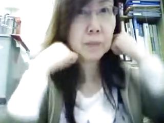 Mature Chinese lady teasing in office